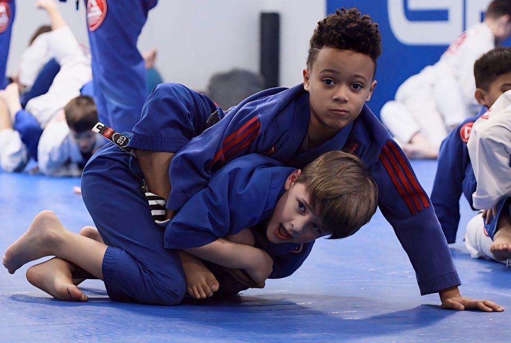 Two kids training Jiu-Jitsu on the blue mats at GBK Kids Martial Arts